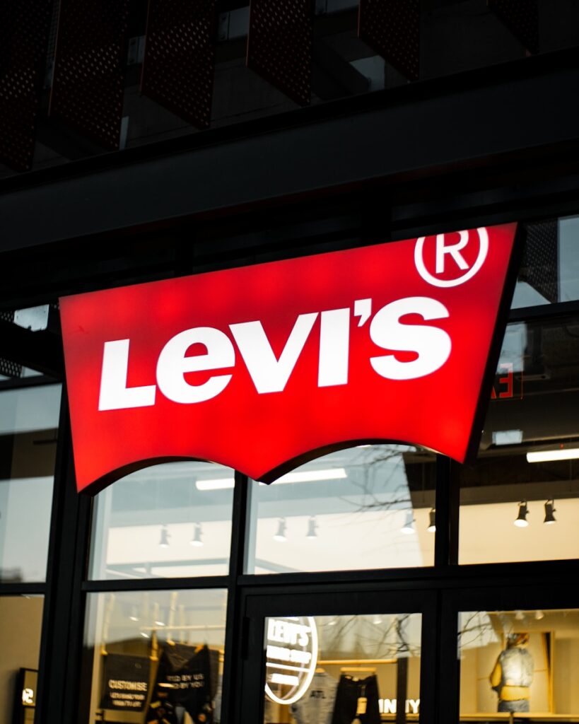 a levi's store sign is lit up at night